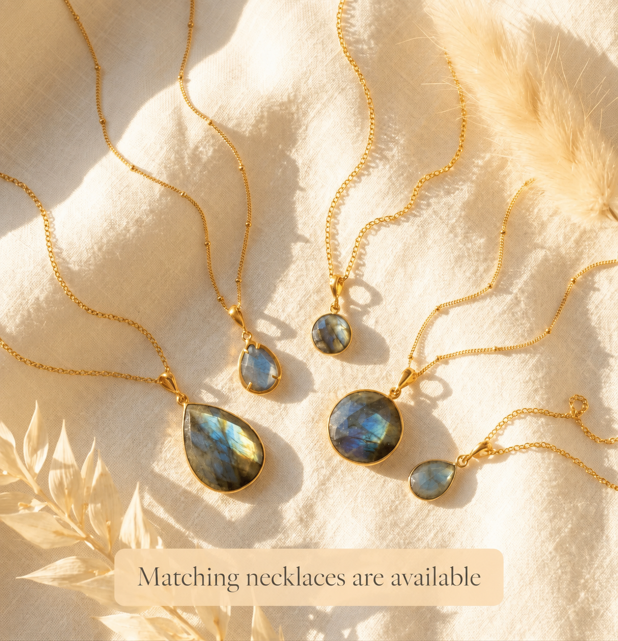 Matching labradorite necklaces and earrings arranged in sunlight, showing coordinated gemstone jewelry options for bridesmaids, birthdays, and gifts for her.