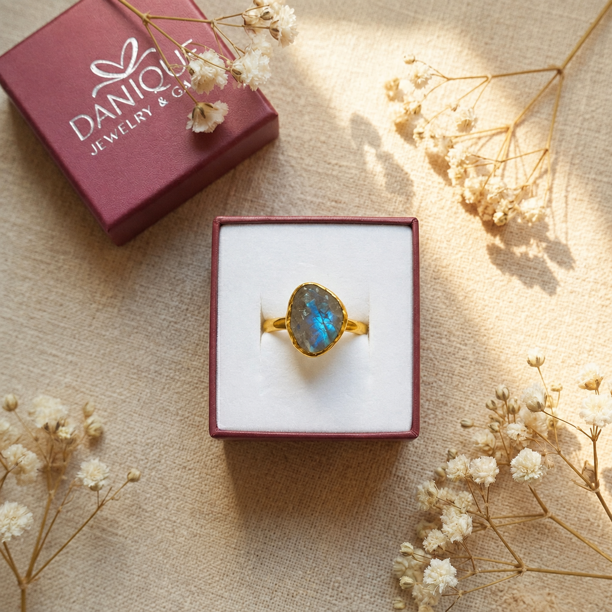 Natural labradorite teardrop ring displayed inside signature Danique Jewelry gift box
