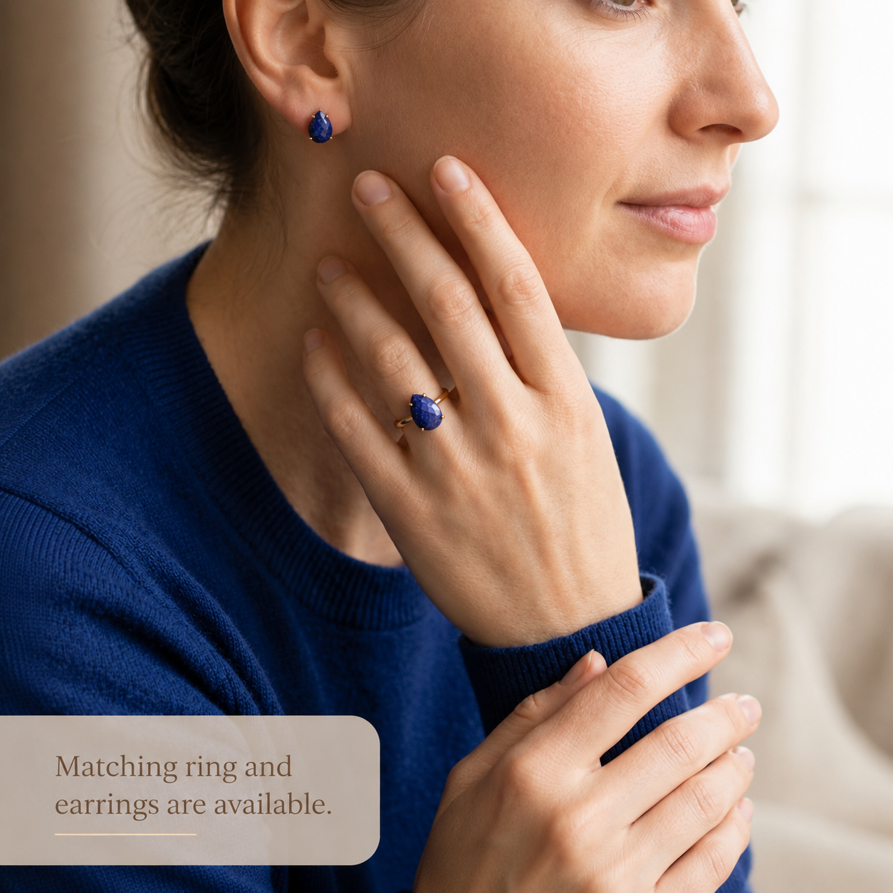Woman wearing lapis lazuli ring and matching blue gemstone earrings, styled as a coordinated birthstone jewelry set.