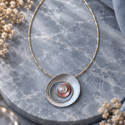 Hand holding Ocean Breeze Sculptural Halo pendant necklace showing 30mm pendant size

