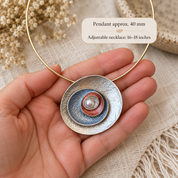 Ocean Breeze Sculptural Halo abstract circle pendant necklace displayed on gray stone