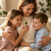 Mother wearing custom birthstone necklace while hugging her children at home