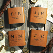 Personalized leather flasks set engraved with initials and wedding date, custom brown whiskey hip flasks on rustic wood background, unique groomsmen gifts, best man or groom gift idea, custom barware for bourbon or scotch lovers, bachelor party favors