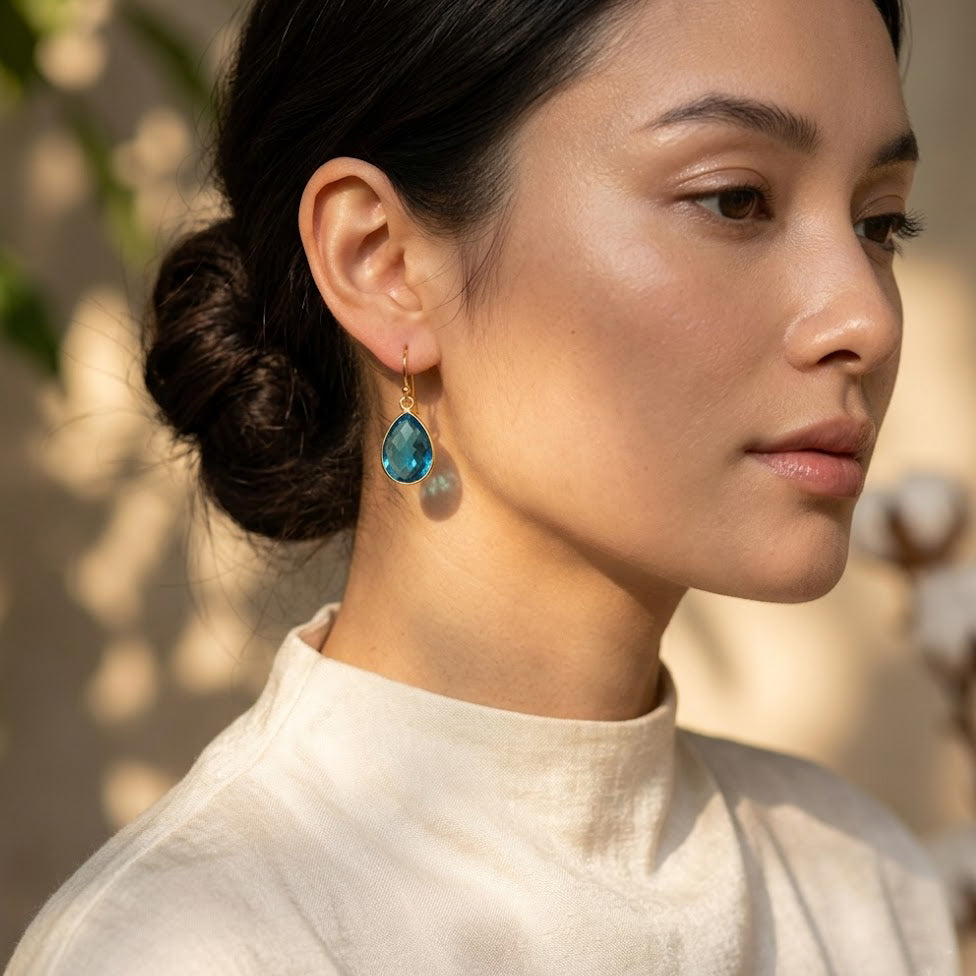 Model wearing London blue topaz teardrop earrings in gold filled, elegant blue gemstone dangle earrings for bridesmaid or gift