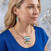  Woman wearing aqua triple barrette statement necklace and matching earrings