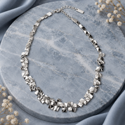 Full Silver geometric pyramid necklace displayed on gray stone with adjustable chain
