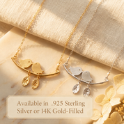 Lovebirds branch necklaces displayed in bright sterling silver and yellow gold-filled finishes.