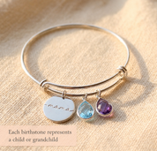 Sterling silver birthstone bangle bracelet with engraved charm and colorful faceted stones, perfect for mom or grandma.