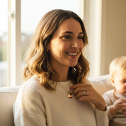 mother wearing personalized mama birthstone necklace with gold engraved disc pendant and custom gemstones representing her children’s birth months including amethyst, emerald quartz, and moonstone; meaningful mom jewelry with option to engrave child names; elegant family necklace handcrafted in sterling silver, gold filled, or rose gold filled; thoughtful Christmas gift, holiday gift for mom, or sentimental keepsake for new mothers