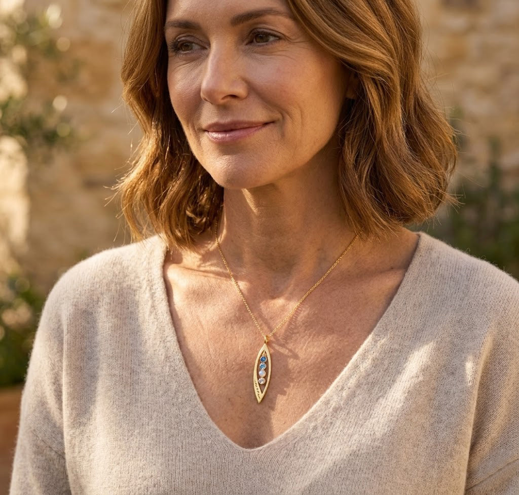 Woman wearing marquise birthstone pendant necklace, dainty personalized jewelry with tiny gemstones for everyday wear