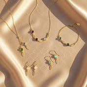 Lifestyle flat lay of personalized birthstone bracelet collection with engraved name tags, matching jewelry set for mom and bridesmaids