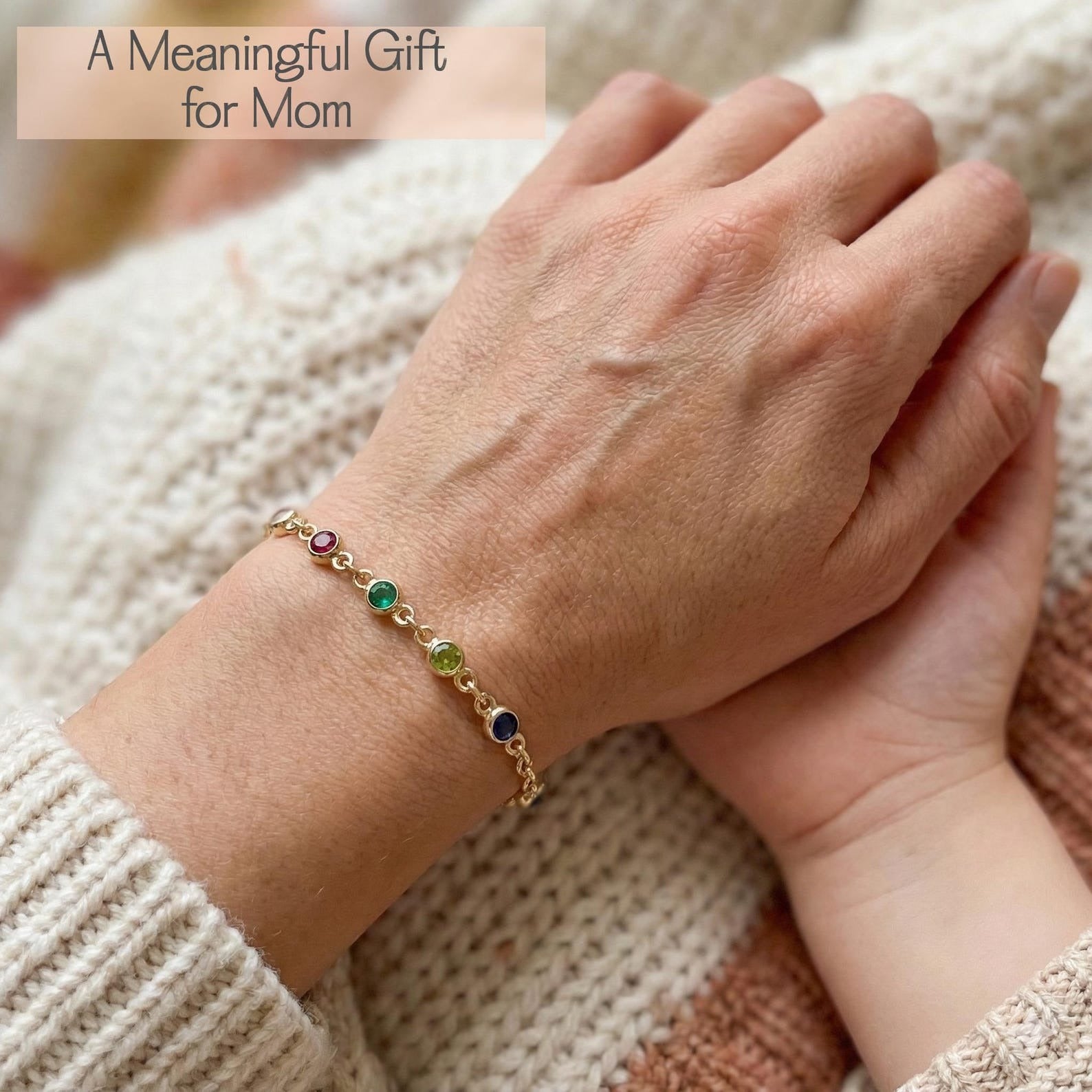 Close-up of hands wearing a personalized birthstone bracelet, symbolizing love and connection between family members. Custom family bracelet featuring tiny gemstones representing children or grandchildren. Thoughtful jewelry gift for mom or grandma, perfect for Mother’s Day, birthdays, or sentimental keepsakes.