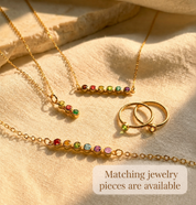 Matching birthstone jewelry set with tiny stud earrings, bracelets, necklaces, and rings
