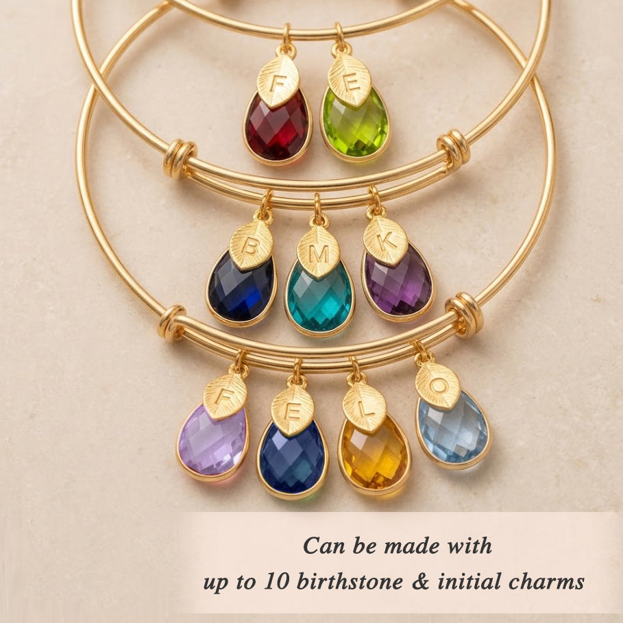 Mother and child wearing personalized birthstone bracelet with initial charms meaningful family jewelry