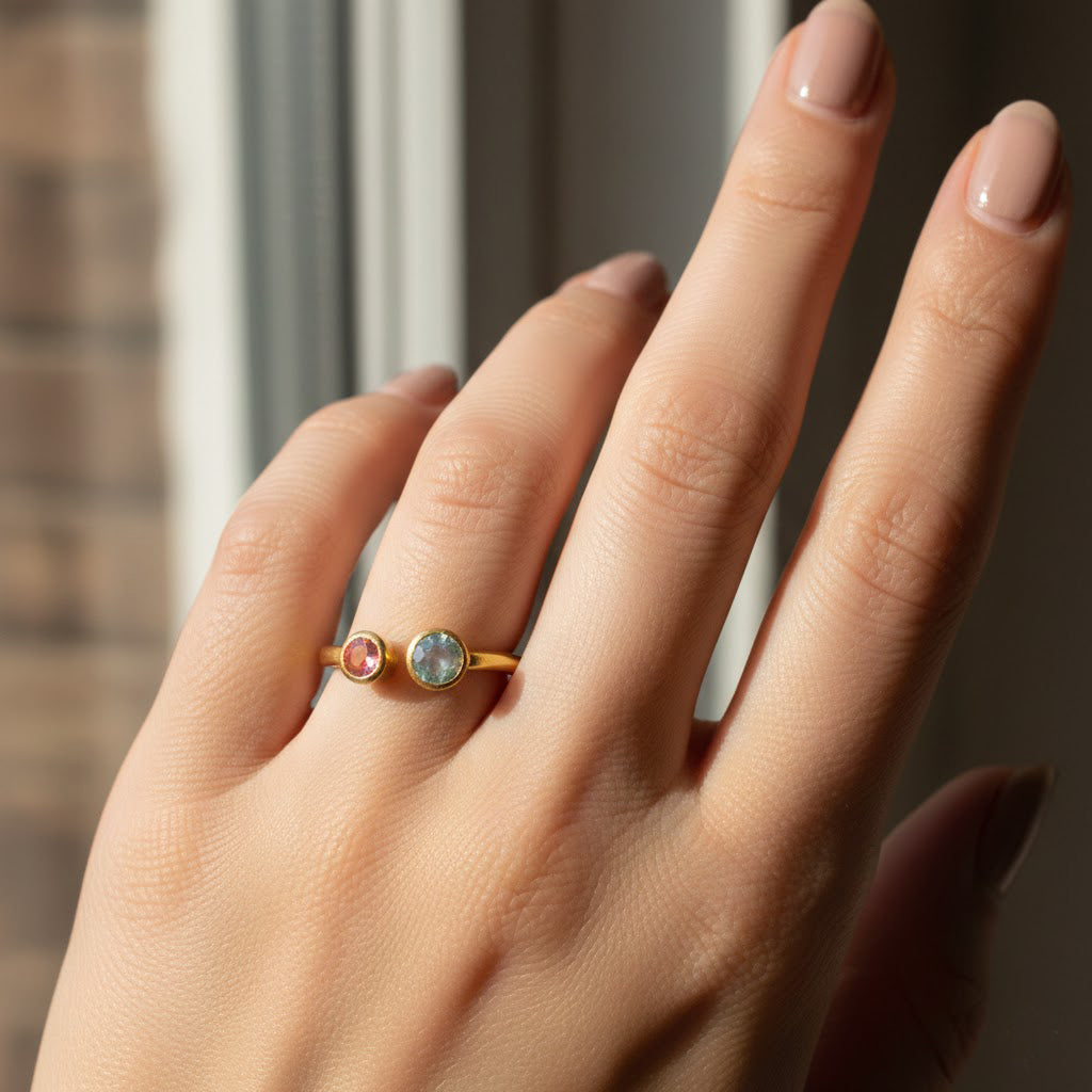 Woman wearing adjustable double birthstone ring, dainty personalized open gemstone ring for mom, grandma, or everyday jewelry