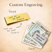A gold money clip with handwriting engraving, shown next to a stack of bills, demonstrating front and back engraving options.