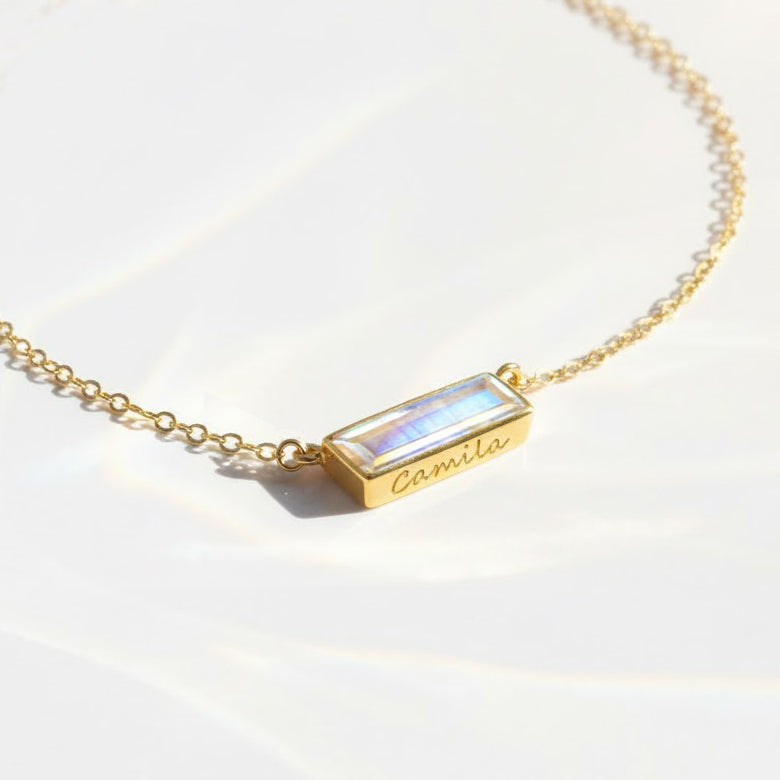 Moonstone bar necklace featuring a dainty bezel-set gemstone in 14k gold filled chain, personalized with custom engraving for a meaningful birthstone bar pendant. This minimalist gemstone bar necklace is perfect as a birthday gift, Mother’s Day jewelry, bridesmaid gift, or everyday necklace for her. Handcrafted in sterling silver, gold, or rose gold filled with elegant Adira design and customizable name or date engraving.