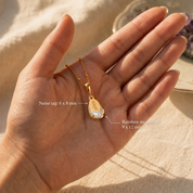 Rainbow moonstone necklace on palm with measurements showing 9 x 12 mm stone and 6 x 8 mm name tag.