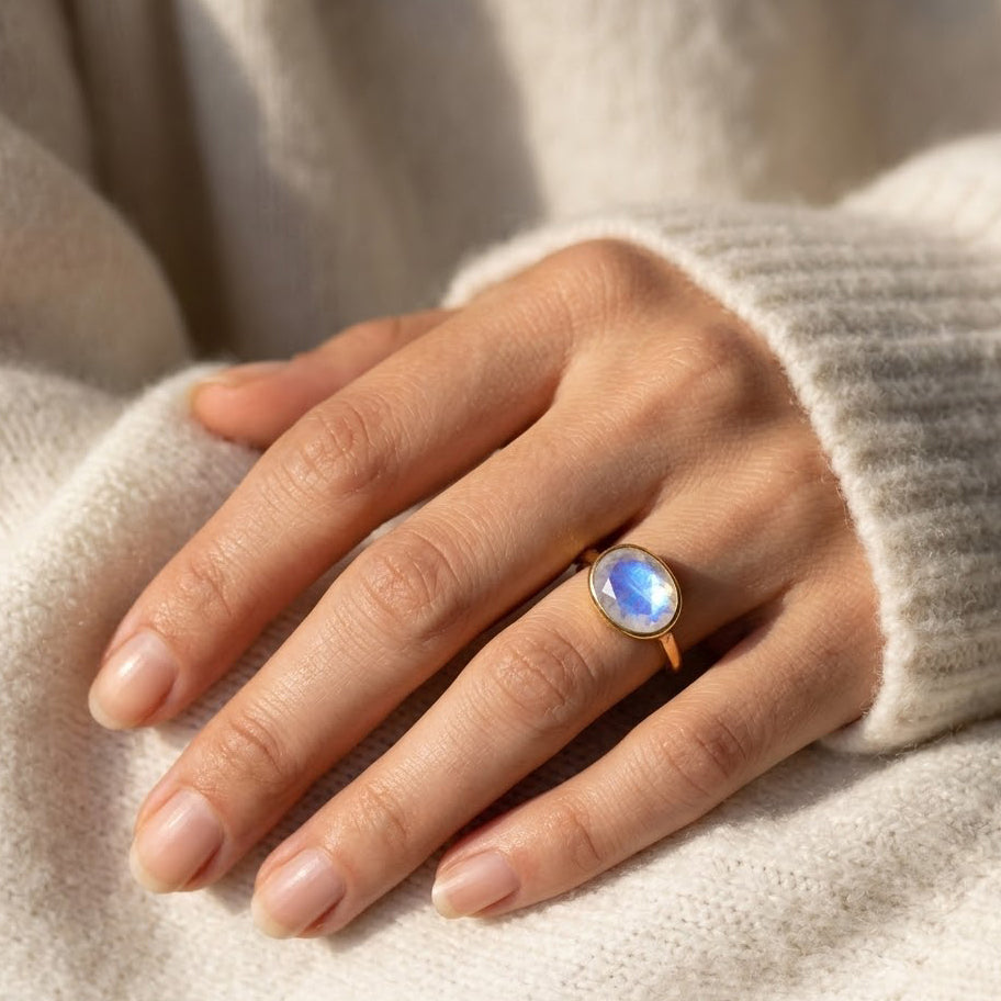 Model wearing oval moonstone ring in gold vermeil, dainty June birthstone ring on hand