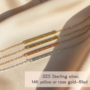 Morse code skinny bar bracelet lineup in .925 sterling silver, 14k yellow gold-filled and 14k rose gold-filled finishes, each slim bar engraved with delicate dots and dashes to spell a hidden message, shown on a soft satin beige background in warm sunlight, minimalist personalized bar bracelet design perfect as a custom gift for mom, best friend, girlfriend or bridesmaids, dainty stacking bracelet for everyday wear.