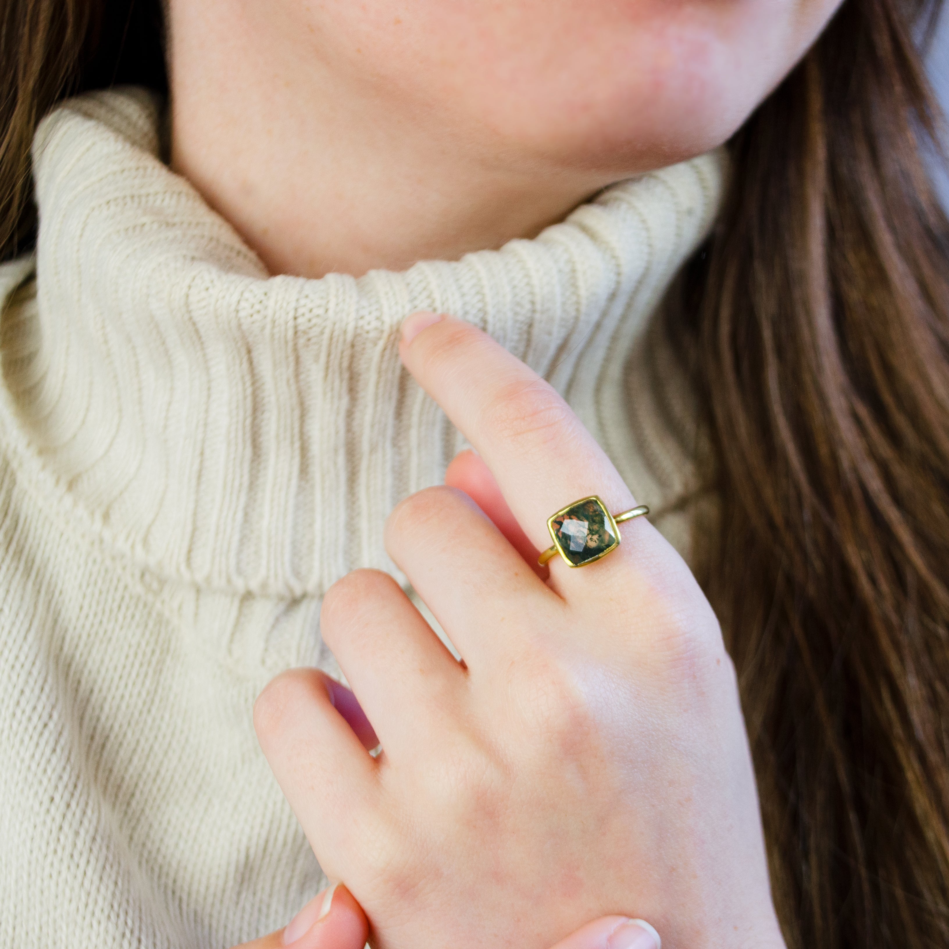Model is wearing Moss Agate gold plated cushion bezel square stacking ring