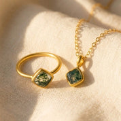 gemstone necklace styled with matching jewelry set, including ring and pendant with cushion cut stone