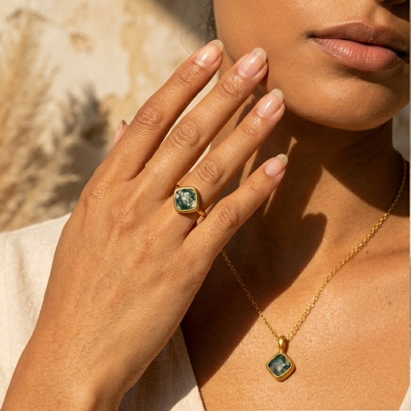 woman wearing cushion cut gemstone necklace with gold chain, elegant minimalist jewelry for layering and daily wear