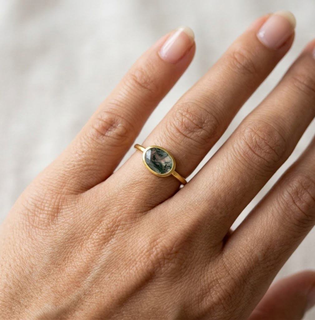 oval moss agate ring on hand, dainty gold ring with natural green stone, everyday jewelry