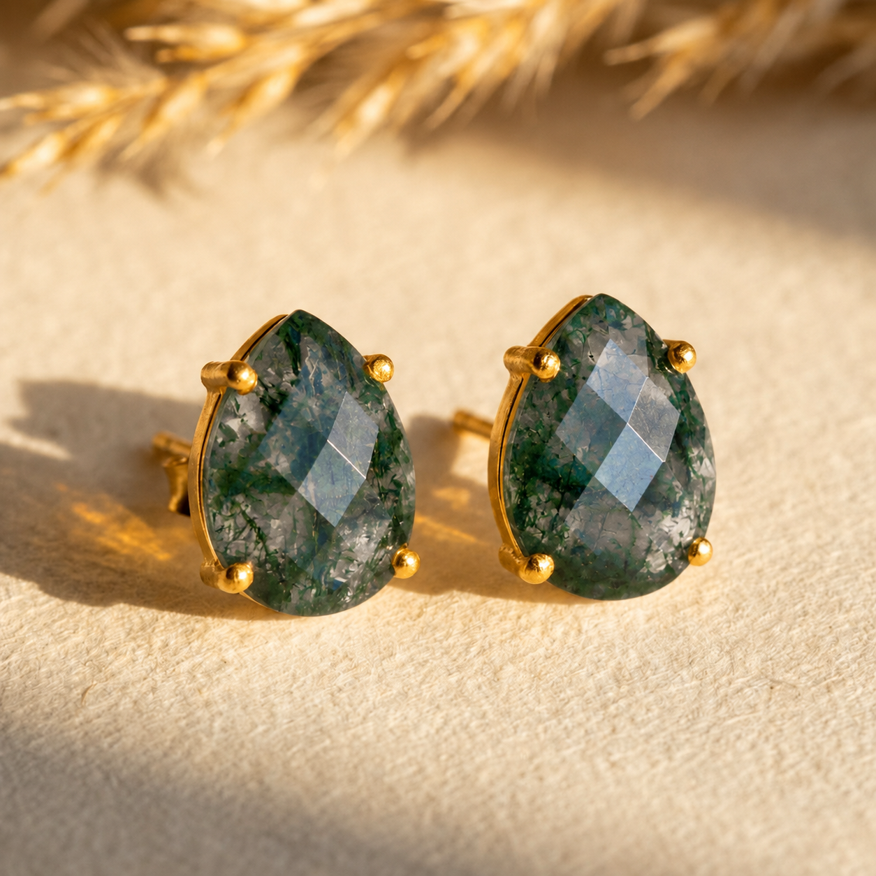 Natural moss agate teardrop stud earrings with faceted green gemstones in yellow gold prong settings