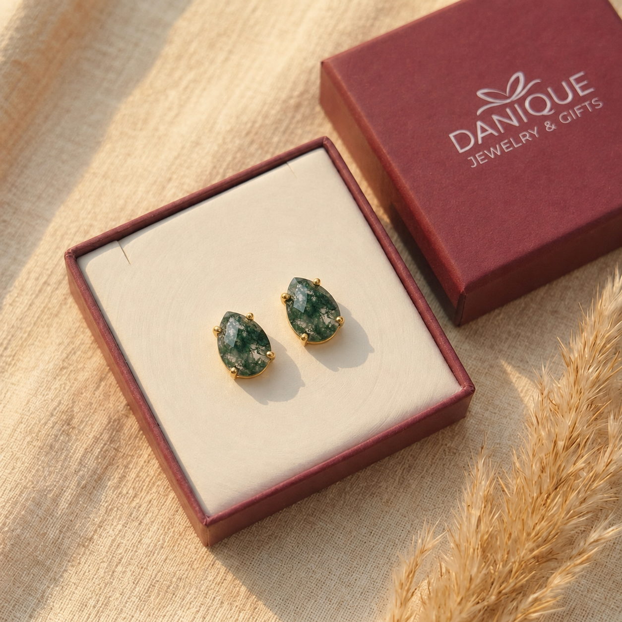 Natural moss agate teardrop stud earrings displayed in Danique Jewelry gift box