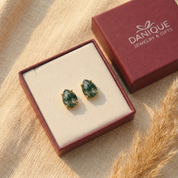 Natural moss agate teardrop stud earrings displayed in Danique Jewelry gift box