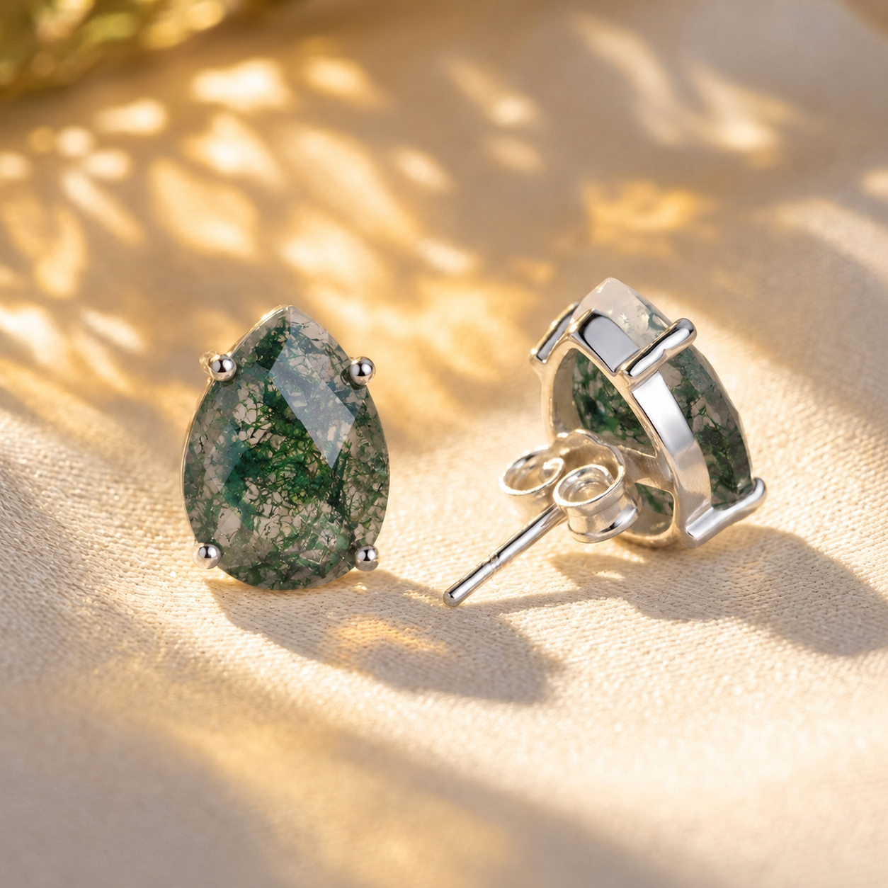 Natural moss agate teardrop stud earrings in sterling silver showing front prong setting and post back
