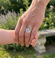 New mom wearing personalized mother child birthstone ring while holding baby’s hand