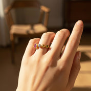 Adjustable custom birthstone ring for mom of three with bezel-set gemstones including one large 5mm stone representing mom and three smaller 3mm stones for each child, shown on a model’s hand. Personalized family ring crafted in gold vermeil, ideal for everyday wear. A thoughtful Mother’s Day gift, birthday gift, or Christmas gift that celebrates motherhood, family connections, and meaningful jewelry for moms of multiple kids.