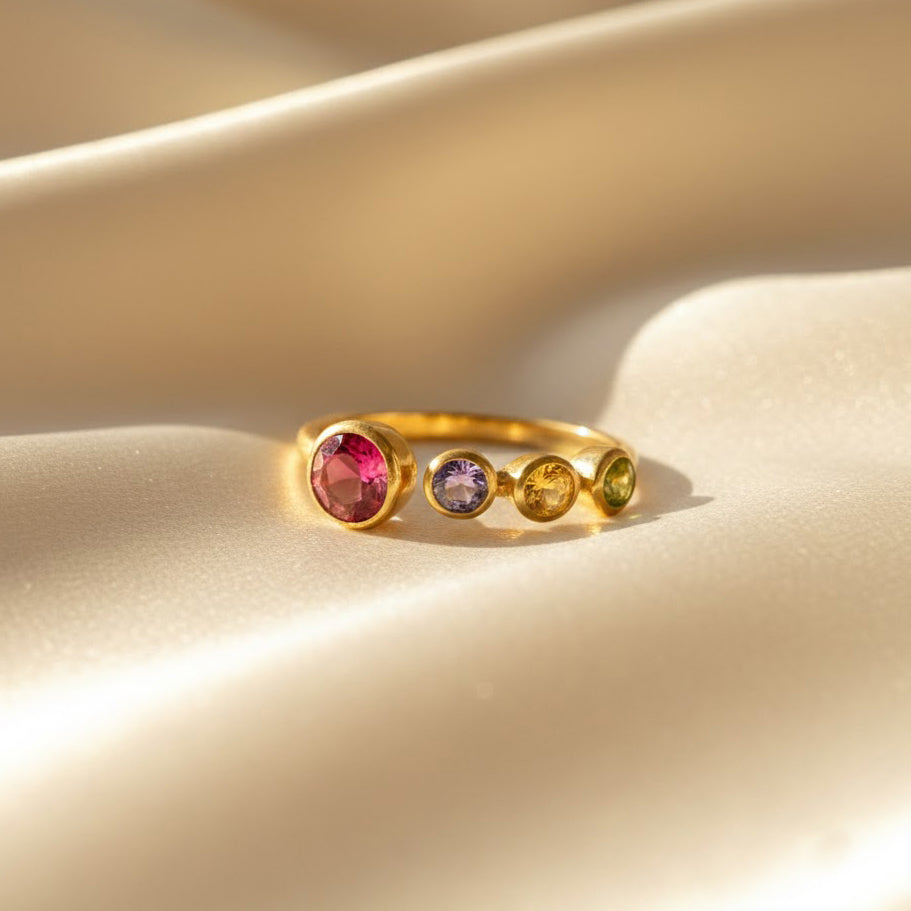 Multi-stone adjustable birthstone ring designed for a mom of three, highlighting a 5mm center gemstone paired with three bezel-set 3mm child birthstones in a stylish open-band setting. Crafted in gold vermeil and beautifully photographed for a luxurious feel. Ideal as a Mother’s Day gift, birthday gift, or holiday gift for moms who love personalized jewelry that celebrates their children and family story.