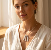 Model wearing custom vertical bar birthstone necklace with engraved name charms