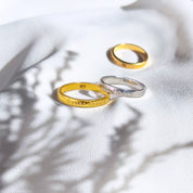 Two gold plated rings with names and a silver ring engraved with til death. Custom Engraved, Name Engraving, Date Engraving, Coordinates Engraving, Initials, Short Quote, Secret Message, Love Note, Roman Numerals, Forever, Always, Promise ring, Soulmate, Best Friends, Family Bond, Anniversary Gift, Birthday Gift, Graduation Gift, Wedding Band, Couple Ring, Memorial Ring, valentine's day, Sentimental, Hidden Message, Minimalist Design, christmas, gift for husband, gift for wife