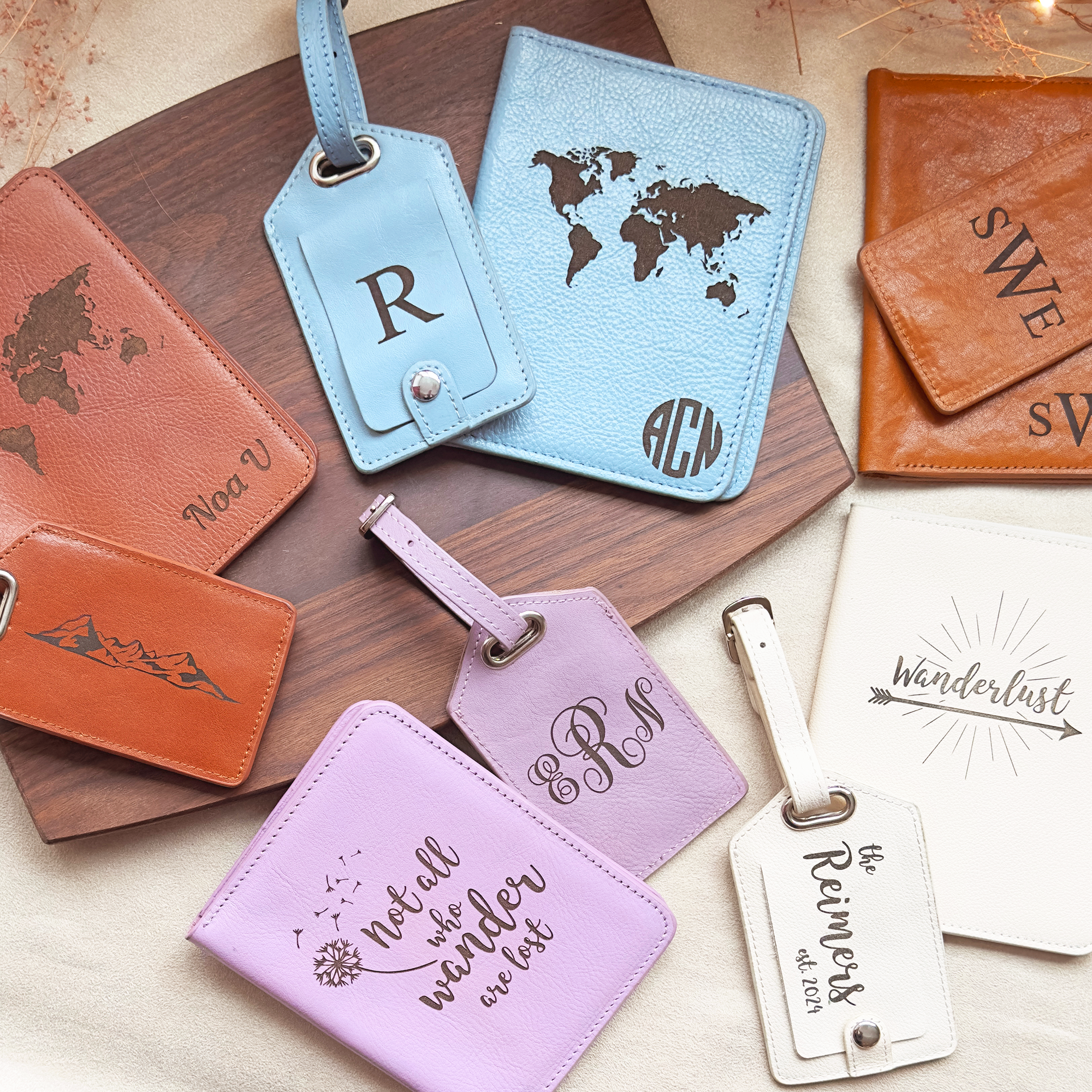 A photo of a variety of leather passport holders and luggage tag sets with different engravings and leather colors. Honey, cinnamon, silver gray light blue, lavender light purple, nude cream white. Personalized travel accessories for everyone.