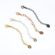 Four necklace extender chains in sterling silver, gold, rose gold, and oxidized finishes with flat disc details. Adjustable length between 1–6 inches for the perfect jewelry fit. Great for extending short necklaces, chokers, or bracelets. Handmade jewelry accessory gift for women, moms, and friends.