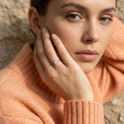 Woman wearing opalite ring gold delicate birthstone ring
