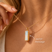 Personalized Opalite vertical bar necklace with hidden side engraving and iridescent October birthstone pendant in yellow gold.
