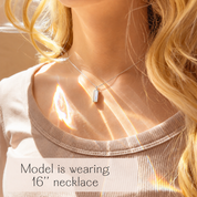 Woman wearing a 16 inch Opalite vertical bar necklace with luminous rectangular October birthstone pendant.
