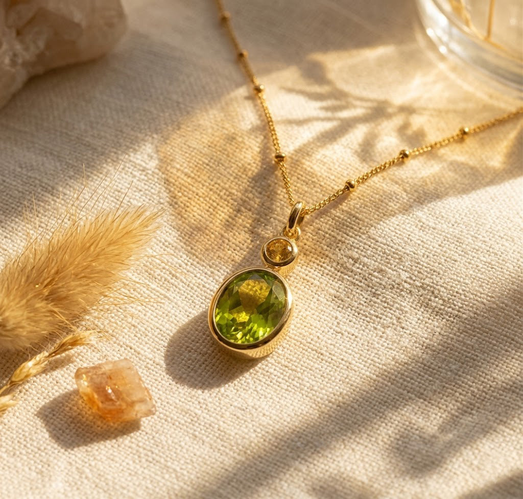 Custom two birthstone necklace with one larger green birthstone and one smaller golden birthstone on a delicate gold chain, perfect for new moms or meaningful gifts.