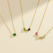 Horizontal oval birthstone necklace featuring custom multi-stone family jewelry design with dainty oval bezel gemstones, shown with emerald quartz, blue topaz, peridot, amethyst, and moonstone stones. Personalized mom necklace ideal for child name engraved gifts, Mother’s Day, birthdays, or Christmas gifting. Handmade in gold, rose gold, or sterling silver and perfect as a sentimental necklace for mom, grandma, or a new mother celebrating her children.