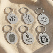 Custom engraved oval keychains displayed in multiple personalization styles including monogram, handwritten messages, photos, and signature engravings. Features durable stainless steel construction with optional double-sided engraving, ten available font styles, and support for handwriting, drawings, fingerprints, or memorial notes. Ideal personalized gift for husbands, wives, parents, grandparents, or best friends for birthdays, anniversaries, Christmas, and Father’s or Mother’s Day.
