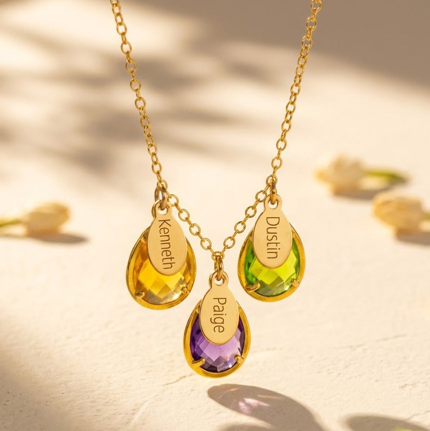 Personalized family birthstone necklace with engraved names and three teardrop gemstones

