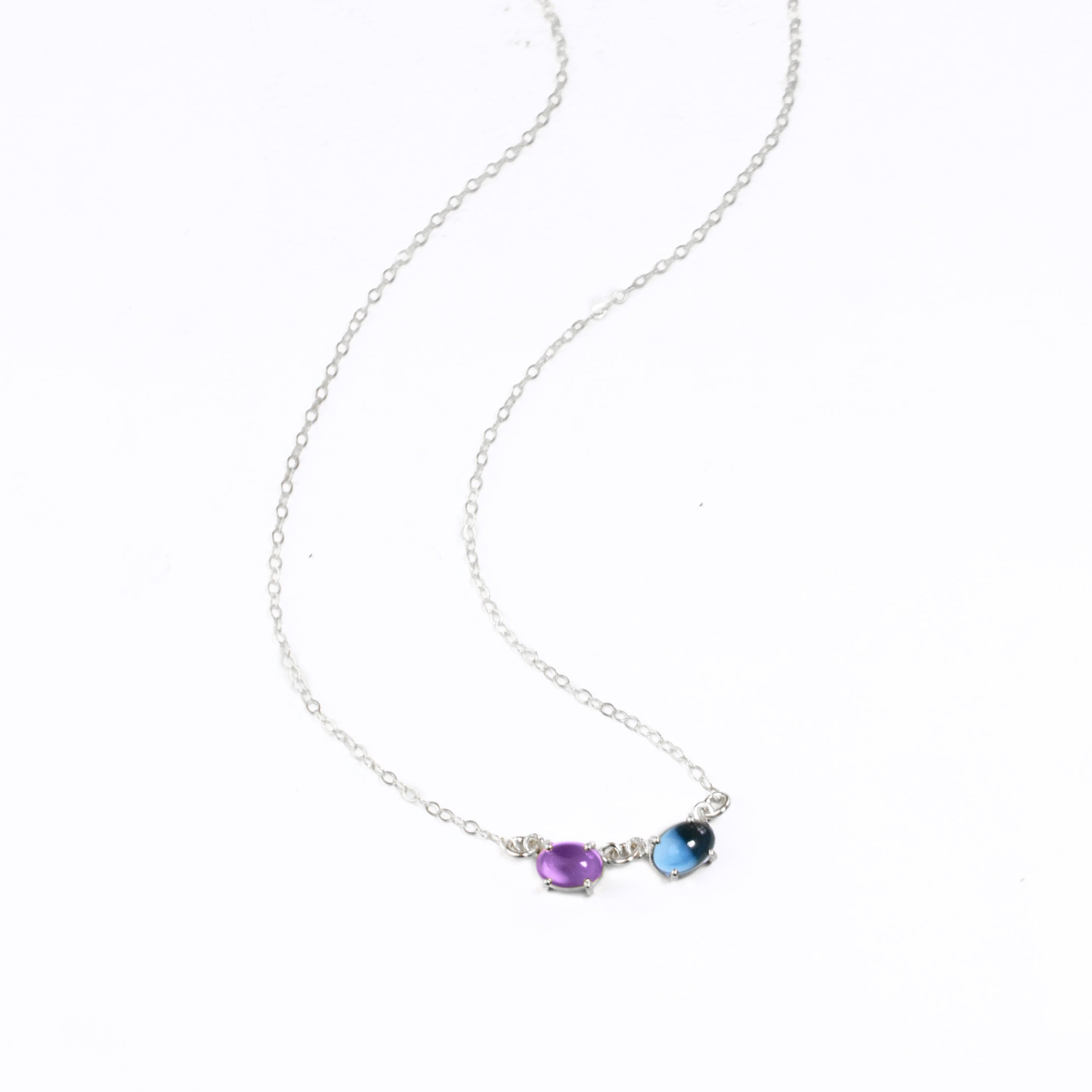 Sterling silver oval prong set cabochon birthstone necklace with purple amethyst and kyanite birthstones. 