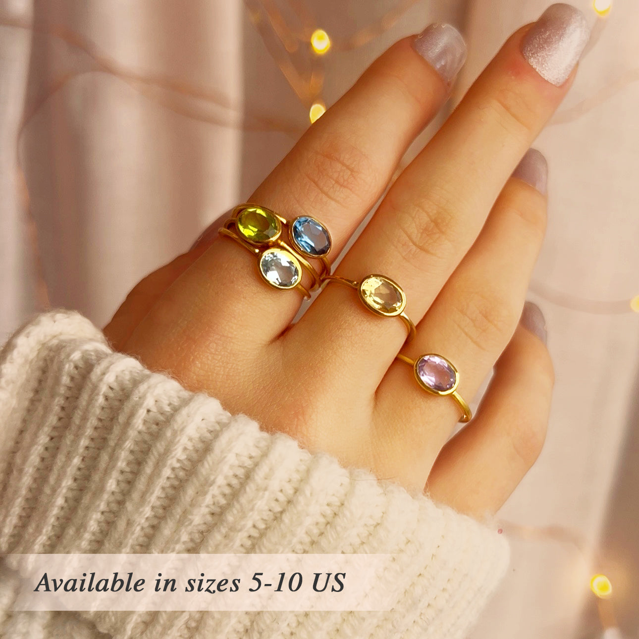 Stacked birthstone rings worn together on fingers including January Garnet, February Amethyst and March Aquamarine, slim gold bands with bezel gemstones, minimalist stacking jewelry style perfect for everyday wear or symbolic family birthstone rings