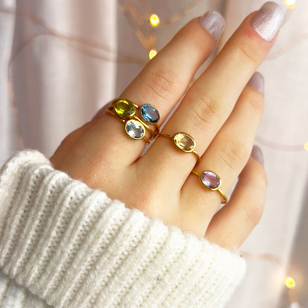 Model stylishly stacking the small oval ring collection. stack set, stacking rings, gemstone ring, birthstone ring, mother's day gift for her, gift for mom, gift for fiance, gift for girlfriend, wedding jewelry, bridesmaid jewelry, anniversary jewelry, anniversary gift, birthday gift, christmas gift, valentine's day gift, valentine's day rings, dainty ring, cocktail ring, statement ring, bezel set, birthstone jewelry, birthstone ring