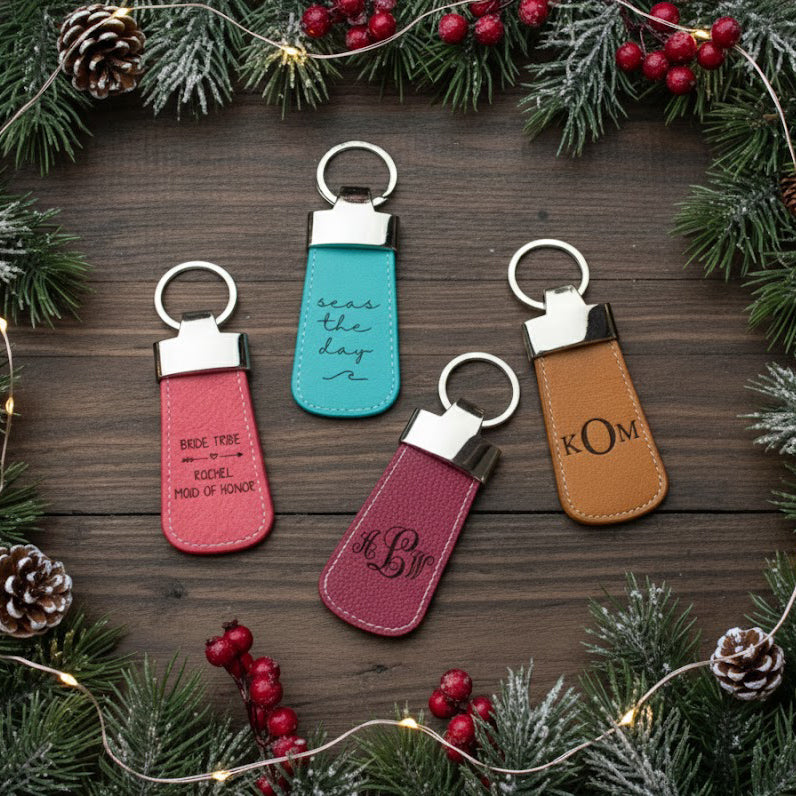 Four leather paddle engraved keychains. Great for wedding parties, groomsman, bridesmaids or for any special loved one. Watermelon with bride tribe design. Turquoise with seas the day and wave pattern. Raspberry keychain with elegance monogram. Honey keychain with formal KOM monogram